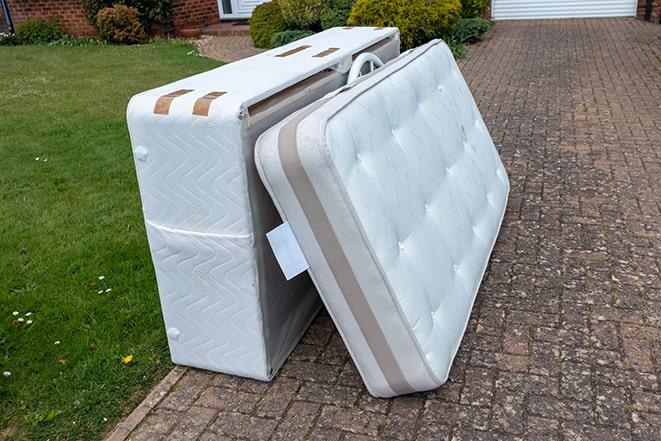 used mattress being taken away for proper disposal